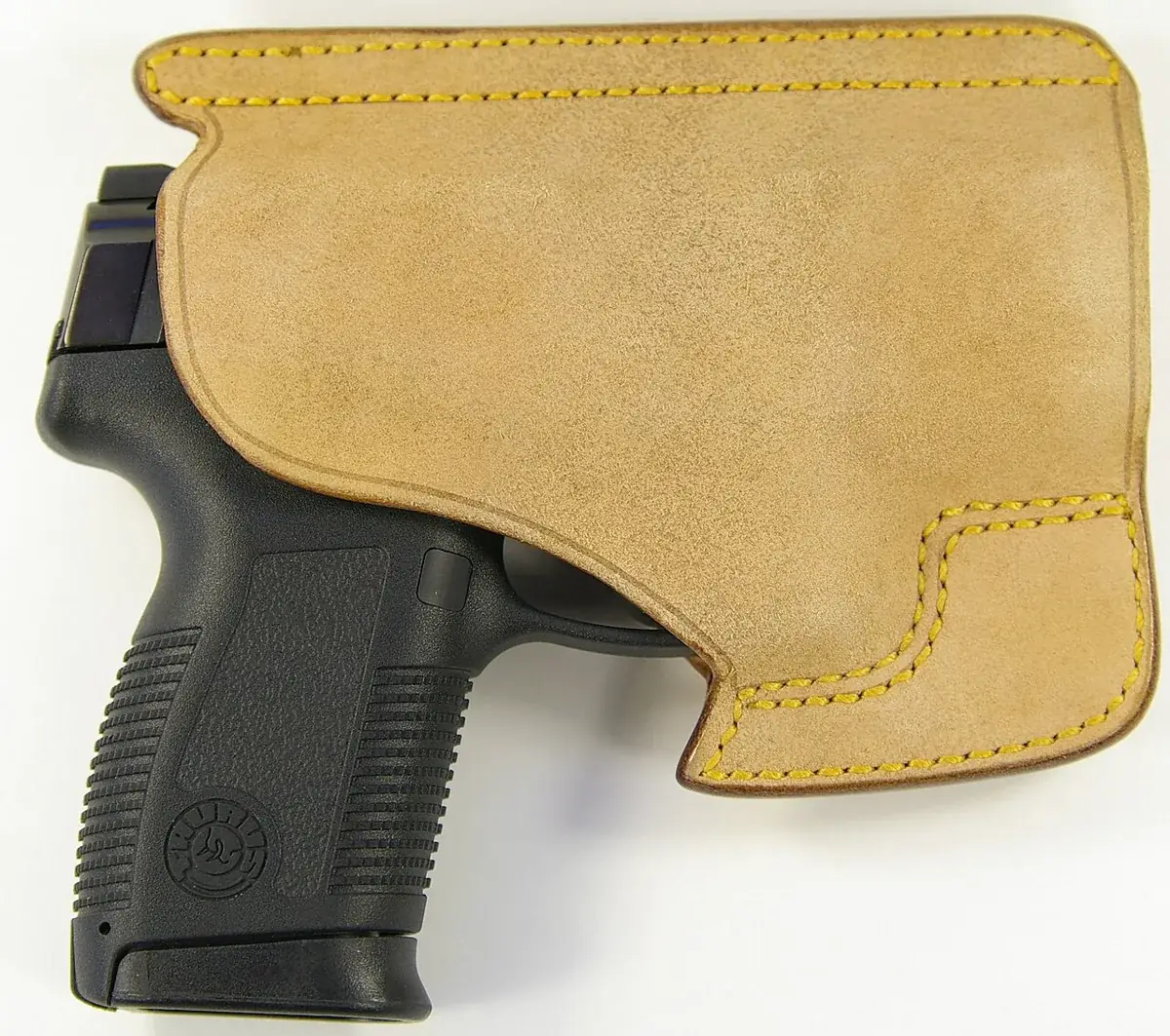 Small pistol in a suede pocket holster