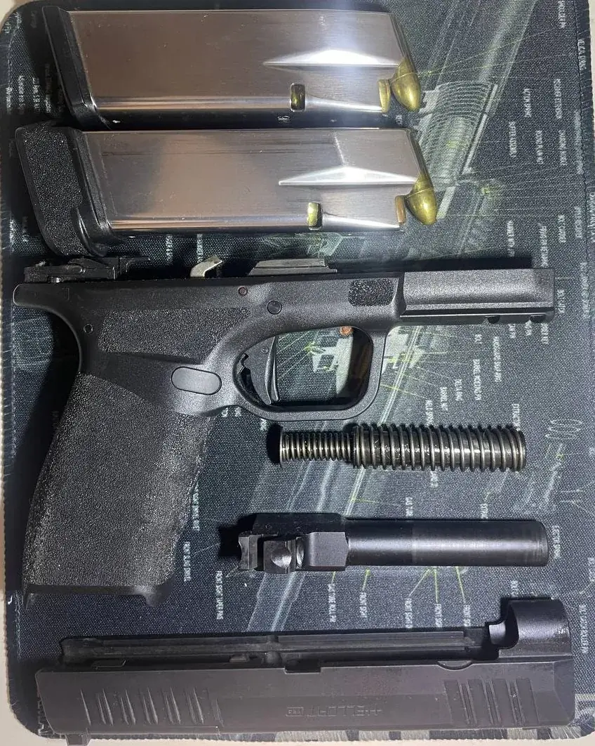 Springfield Hellcat Pro field-stripped with magazines